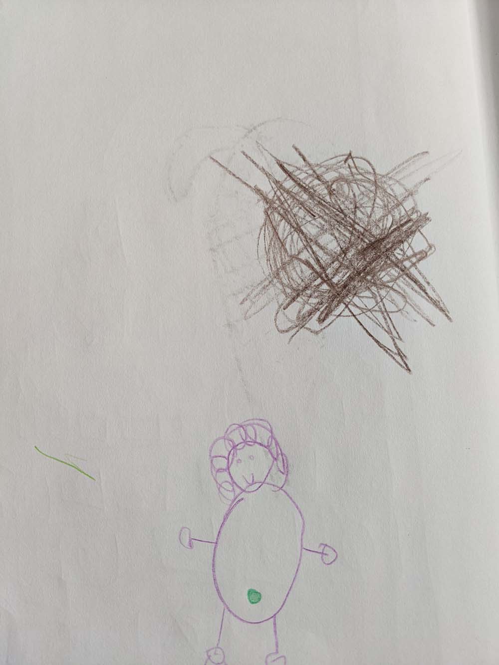 A drawing of a little girl with a green belly button and curly hair, below a brown scribble.